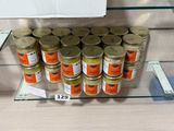many jars of mustard sitting on a shelf in a store