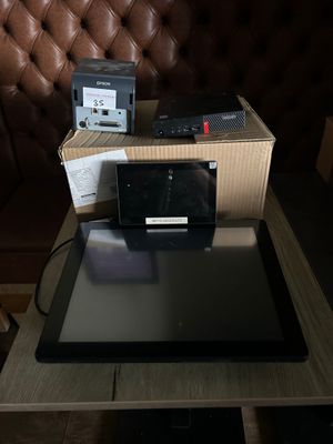 a tablet computer sitting on top of a table next to a box