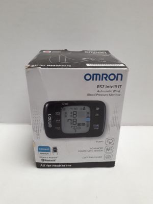 an omron blood pressure monitor in a box on a white surface