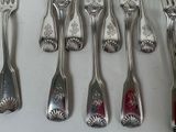 a lot of silver spoons and forks on the table