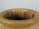 a wooden vase that has a brown design on it