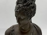 a close up of a statue of a woman wearing a dress