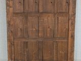an old wooden door is sitting on the floor in front of a wall