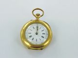 a gold pocket watch with roman numerals on the face