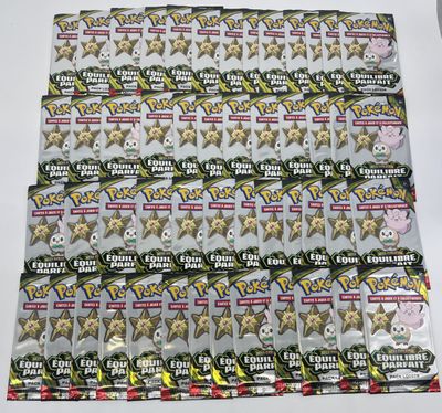 a lot of pokemon trading cards on the table