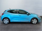 a blue car is parked in a room with a white wall