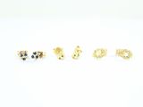 three pairs of gold earrings with sapphire stones on a white background