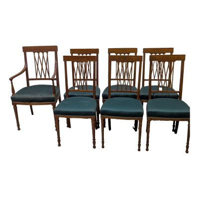 a set of four chairs with blue upholstered seats