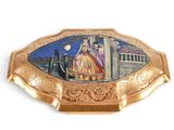 a gold plate with a picture of a man and a woman on it