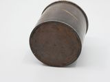 an old wooden barrel sitting on top of a white surface