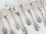 a lot of silver spoons and forks on a white table