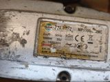 a close up of a metal plate with a sticker on it