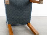 a blue chair that has a wooden frame on it