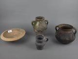 several different types of vases and bowls on a gray surface