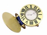 une horloge avec des chiffres romains et un stylo posé devant