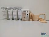 trois tubes de lotion et une boîte en bois contenant des brosses à dents