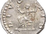a silver coin with a man sitting on top of it
