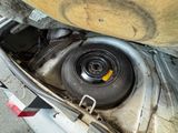 a close up of a car ' s engine with a flat tire