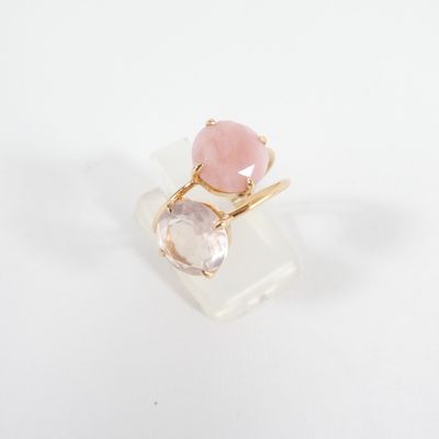 a close up of a pink and white ring on a white surface