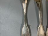 five spoons and two spoons sitting on a table