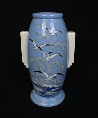 a blue vase with seagulls painted on it