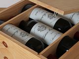 bottles of wine are in a wooden box on a table