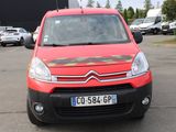 a small red van parked in a parking lot