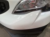a close up of a car ' s headlight and the front end of it