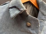 a jacket hanging on a hanger on a wall