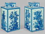 pair of blue and white vases with flowers and birds on them
