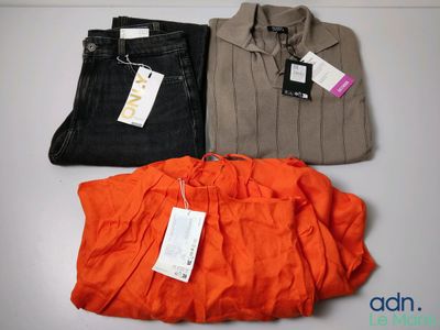 three pairs of men ' s shirts and pants sitting on a table