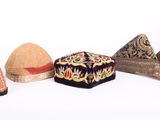 Plusieurs types de chapeaux sont alignés sur une surface blanche