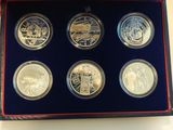 the four coin set is in a blue box on a table
