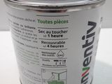 a can of paint sitting on a white table