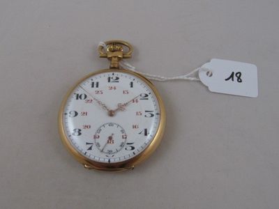 a gold pocket watch with a tag on it