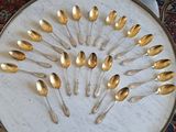many spoons arranged in a circle on a table