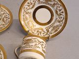 three cups and saucers are sitting on a white surface