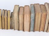 books stacked on top of each other on a white surface