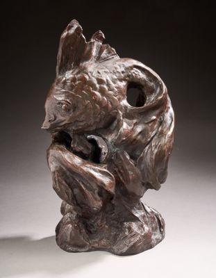 bronze sculpture of a dog ' s head on a white surface