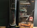 a vacuum that is sitting on a table next to a book