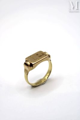 a close up of a gold ring with a diamond on it
