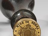 a close up of a bottle opener with a seal on it