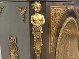 a wooden cabinet with a gold decoration on it