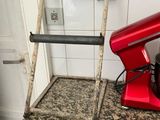 a red mixer on the counter next to a red mixer