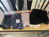 a table with a lot of clothing on top of it
