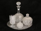 a picture of a glass bottle and a glass vase on a tray