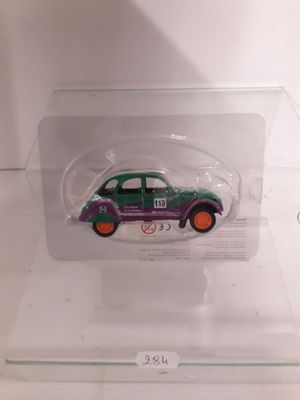 a green and purple car in a clear box