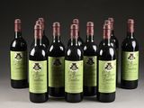 six bottles of wine are lined up in a row on a table