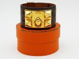 two orange and black leather bracelets with a gold buckle