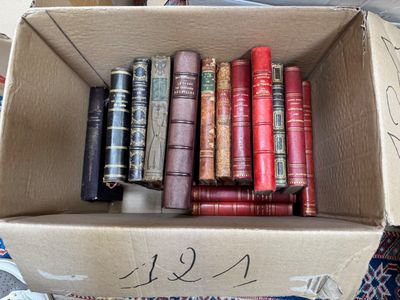 a box full of old books sitting on the floor